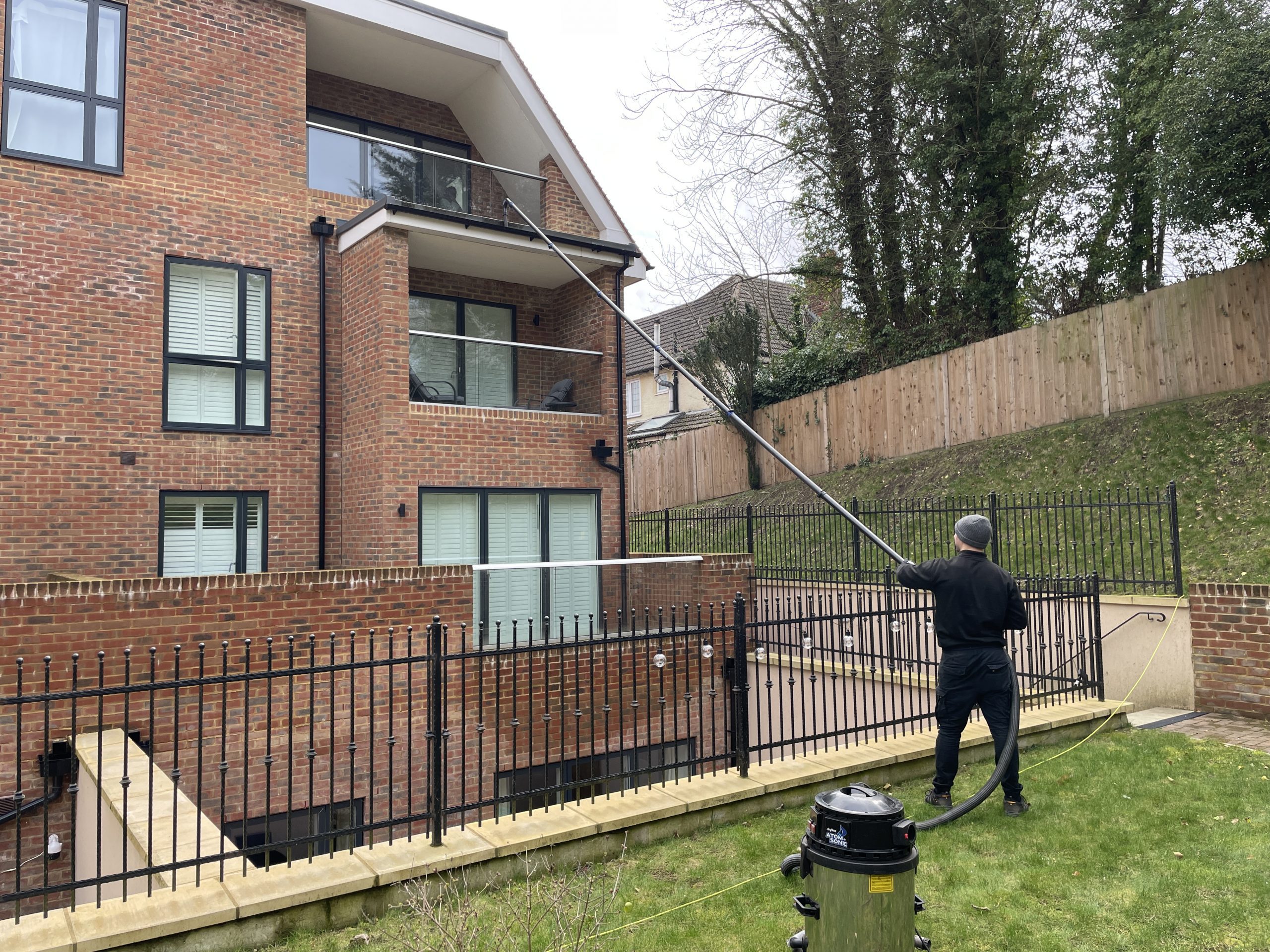 man cleaning a gutter in a commercial property maintenance